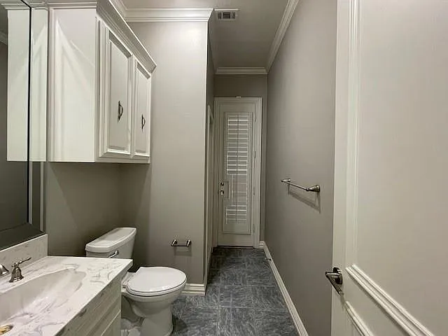 Half bath with vanity and ornamental molding