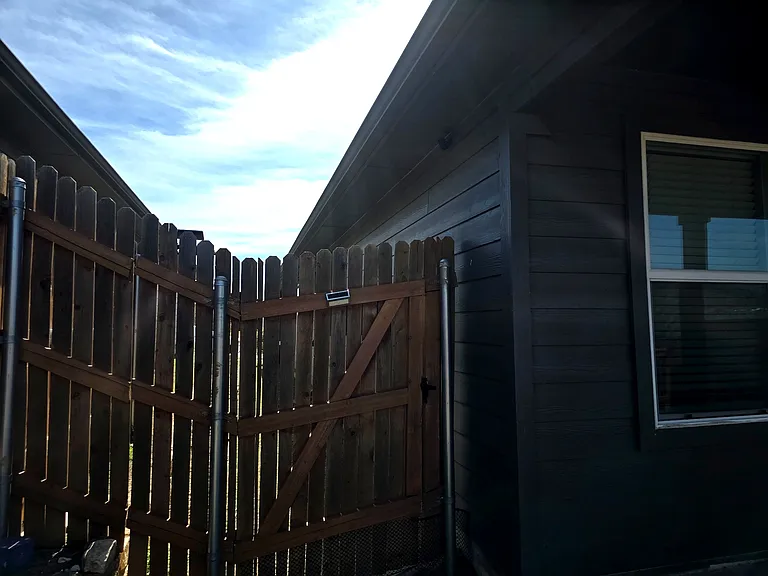 Secure gated entry to backyard for added privacy.