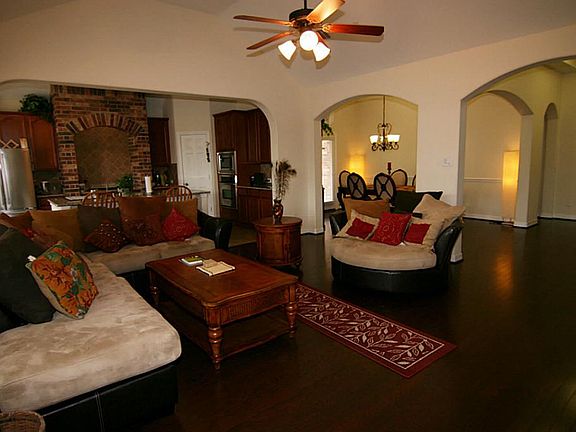 Awesome view of the family room with arched entry and gorgeous hardwood floors.