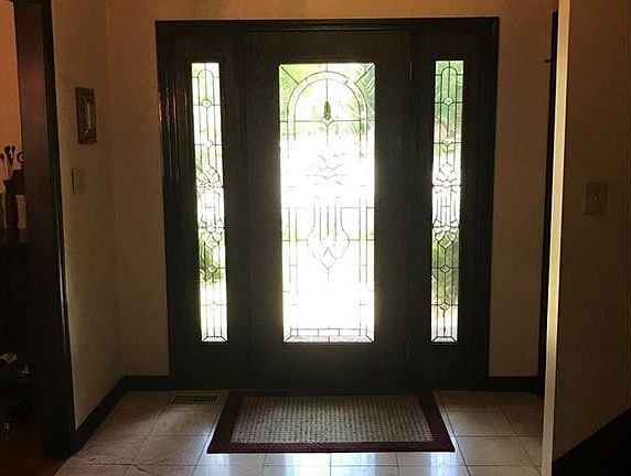 View of entry way! notice the gorgeous front door and the large foyer.  High ceilings in entryway!