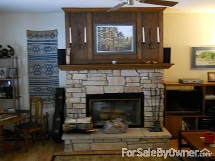 Livingroom with stone fireplace
						:
						Large livingroom with laminate floor and 9 ft. window with French door to deck