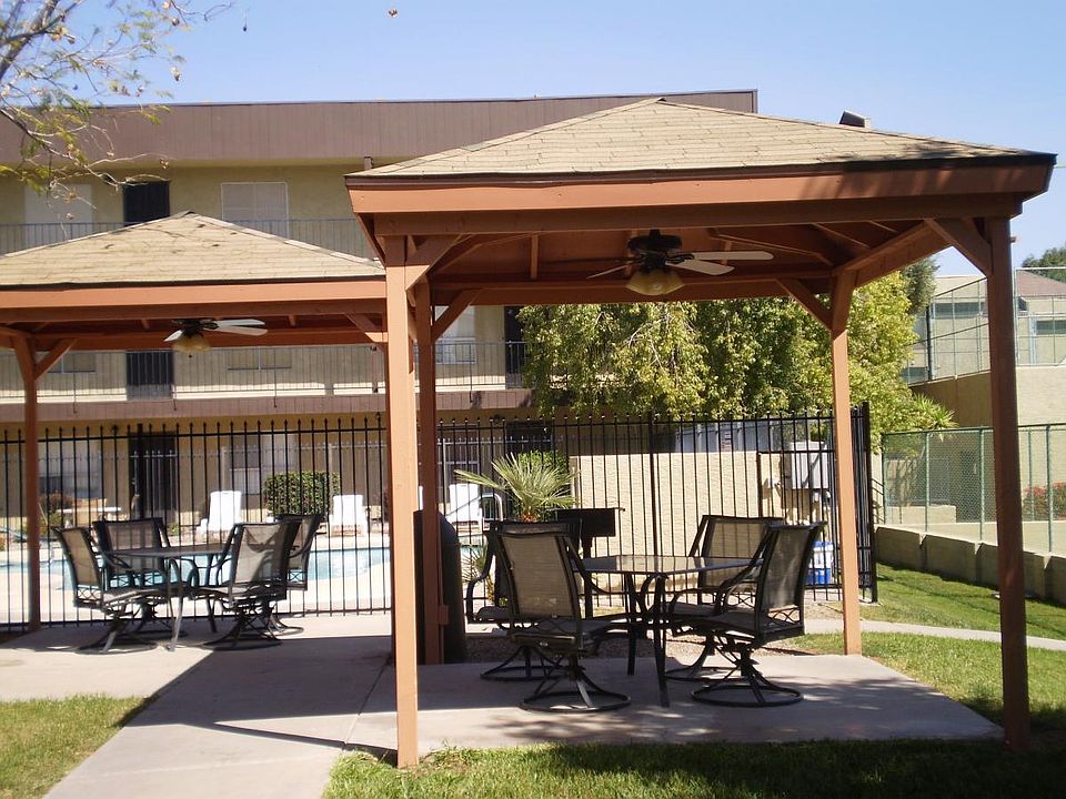 One of multiple ramada's with table, chairs, fan, light and BBQ Grill.