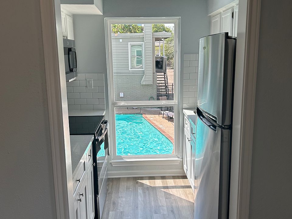Fully renovated kitchen with all-new appliances overlooking the pool.