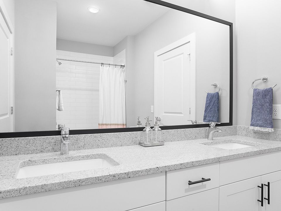 Explore this sleek bathroom featuring dual sinks and a touch of luxury.