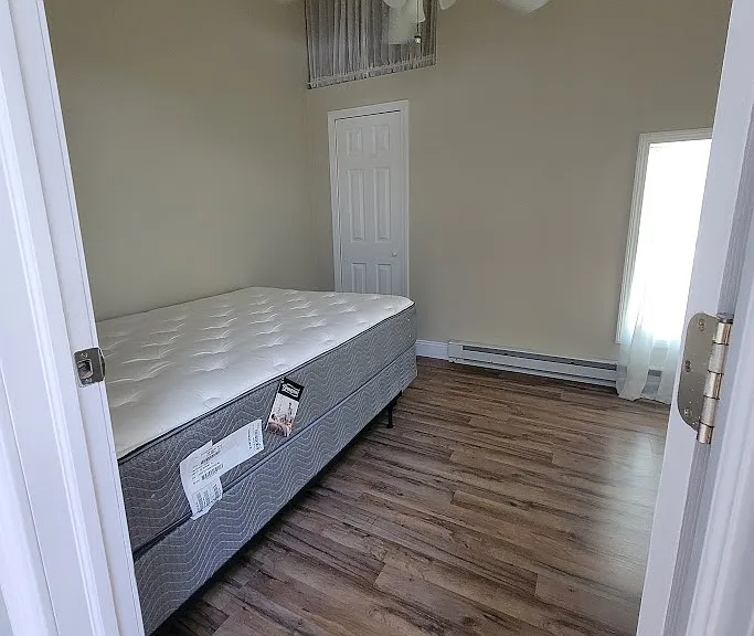 Bedroom fits full size bed. Extra storage above closet.