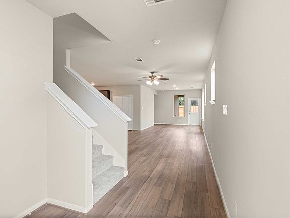 The welcoming entryway seamlessly transitions into the heart of the open-concept living space