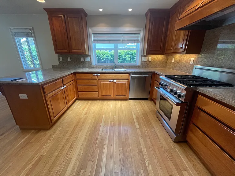 Kitchen-Abundant custom cabinetry paired with a dedicated utility station hosting premium integrated appliances from top brands including GE, Whirlpool, Bosch and KitchenAid.
