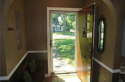 Welcoming foyer with arched doorway hardwoods