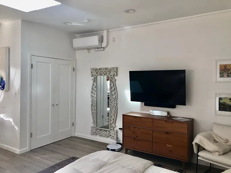 closet and tv with dresser