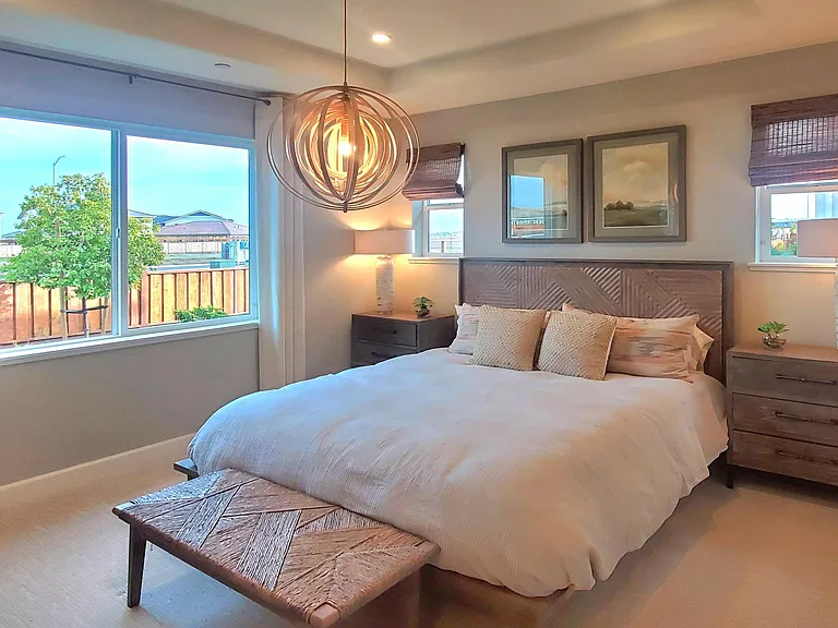 Modern and bright Master room with a larger walk-in closet, and a cooling fan.