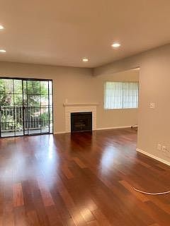 Living room with faux fireplace and balcony