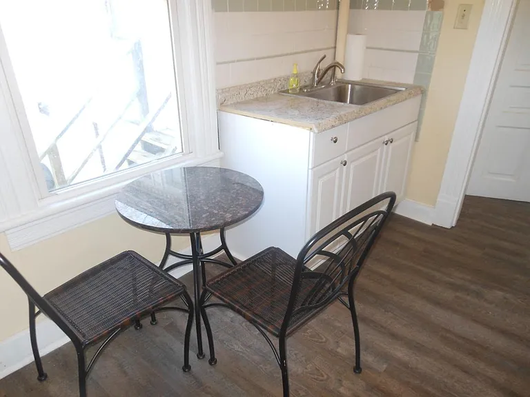 Attractive marble top kitchen table near east window in kitchen
