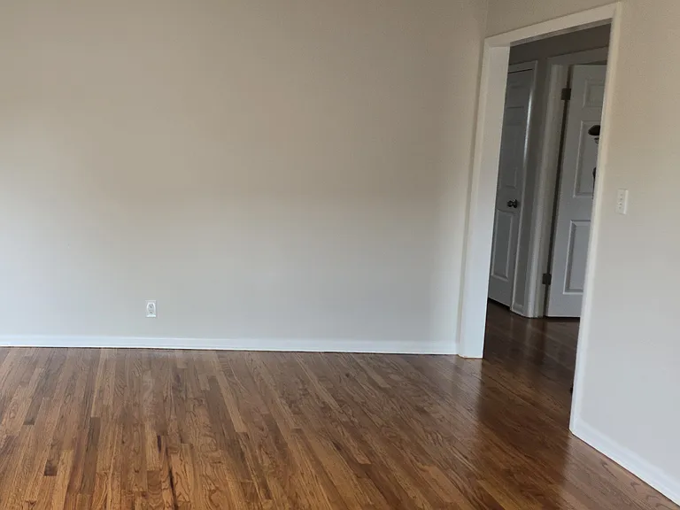 Large living room now with brand new & finished hardwood floors.