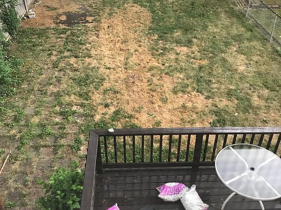 Fully fenced backyard with wooden deck