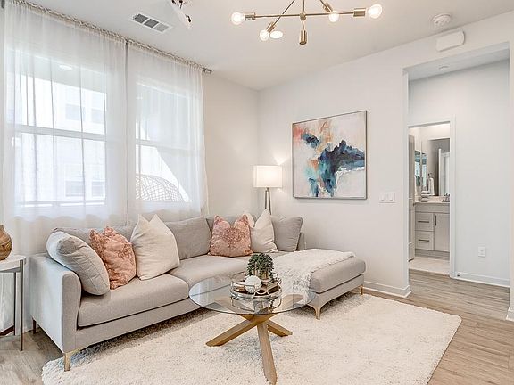 Beautiful chandelier, wood-like flooring and bright windows welcome you as you enter from the front door