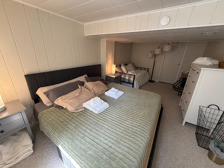 Third bedroom with king bed plus twin daybed and pull-out twin _ the twins convert to a second king with a connector. Large closet, steps from the downstairs full bathroom. Sleeps 4