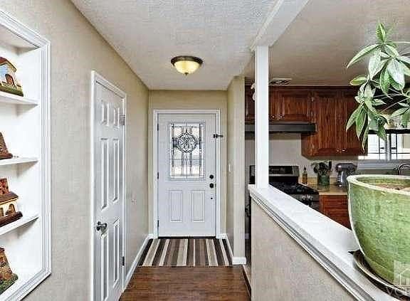 Laminate flooring, ceiling light, coat closet.