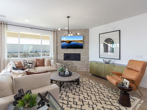 Representative Photo - Spacious great room accented by a cozy fireplace