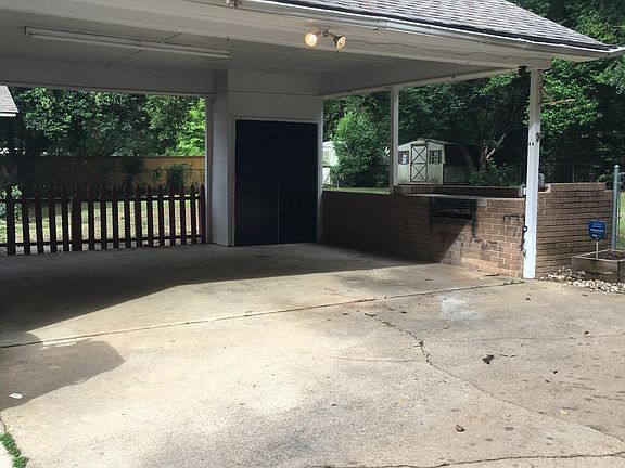 Double carport with built-in grill. Use it for your cars or for a covered patio.