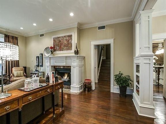 Entry way with living room featuring marble surround firepla