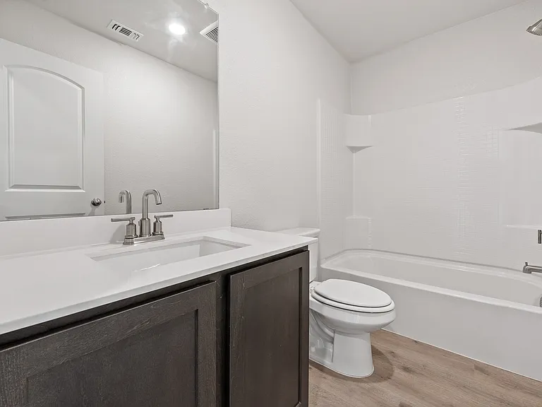 The secondary bathroom of the Rio Grande has a large vanity space and a shower-tub combo.