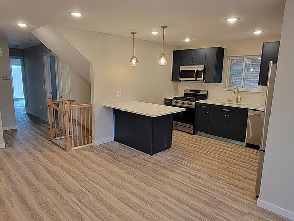 Kitchen with adjacent dining and living area
