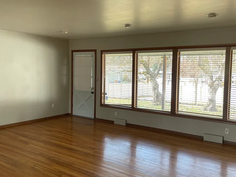 Bright Living Room Featuring Large Picture Windows