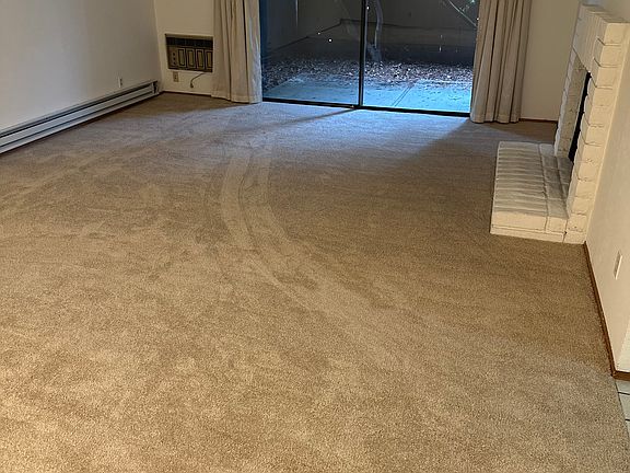 Living room with newly installed carpeting.