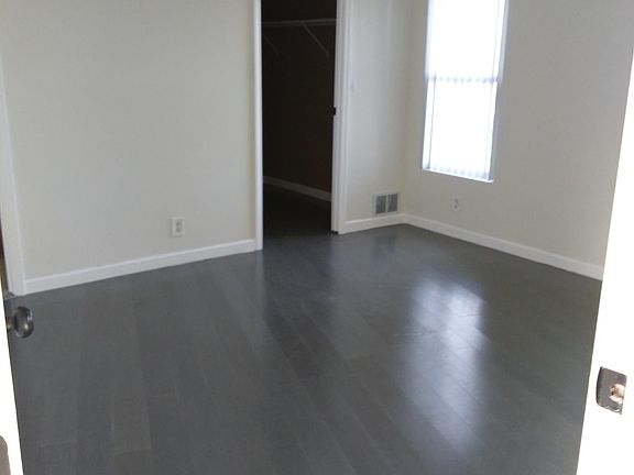 Master bedroom with walk in closet and ceiling fan.