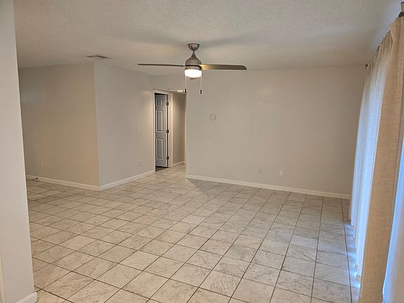 Living room showing the hallway which leads to the 3 bedrooms on one side of the house