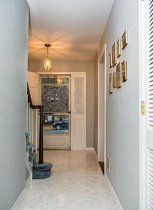 Center hall foyer features a neutral tile floor