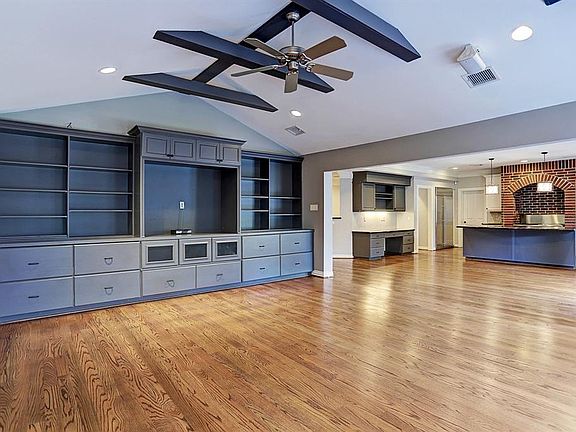 Family Room with views of the kitchen and french doors that lead to backyard.