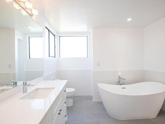 Primary bathroom consists of a large bathtub, double sink vanity and shower.