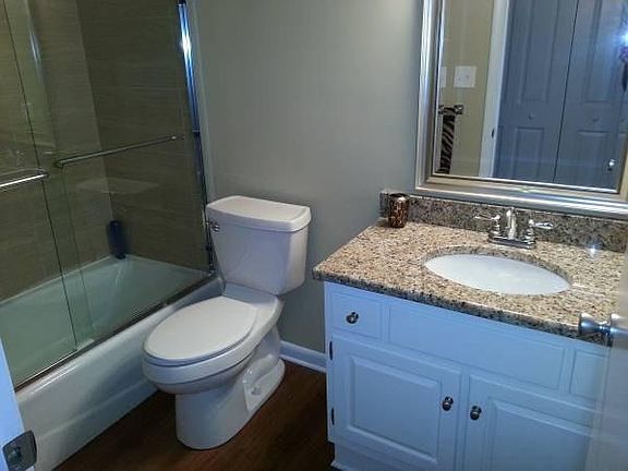 Remodeled Bathroom with granite countertop, New toilet.