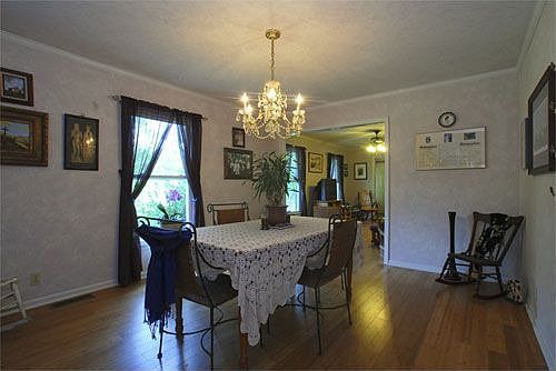 Spacious dining room with crown molding.