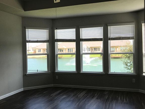 Master bedroom with large bay windows and more incredible lake views.