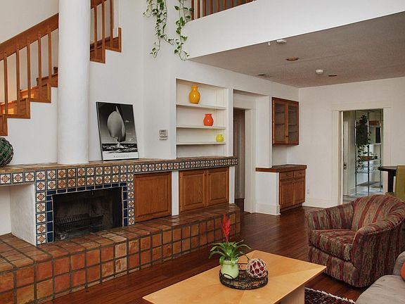 Living with hardwood wood floors, cathedral ceiling, fireplace & built-ins