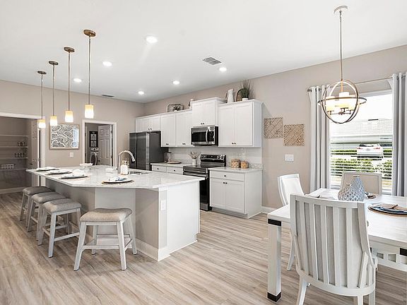 Your new kitchen is beautifully designed with quartz, 36-inch cabinets, Samsung SS appliances, a til
