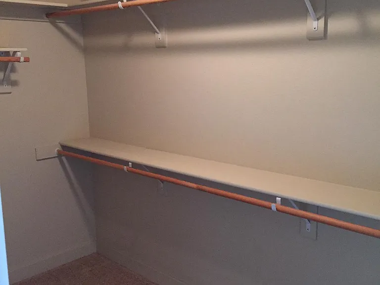 Walk-in closet in master bedroom.