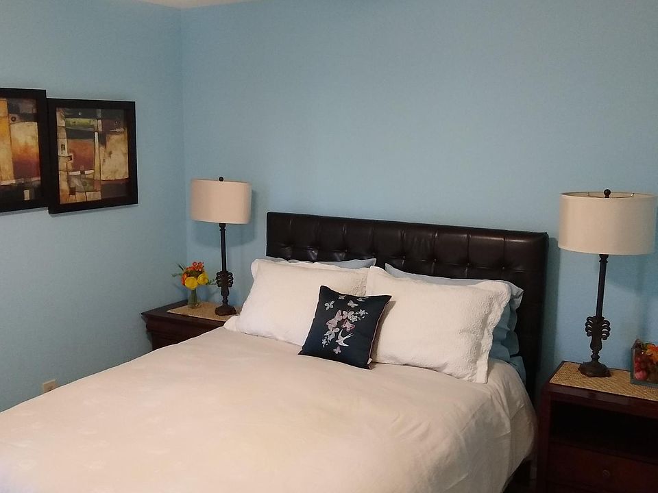 Second bedroom with queen bed, nightstands and bed lamps. Also a ceiling fan and overhead light that is operated with a remote. Same relaxing color as the master bedroom.