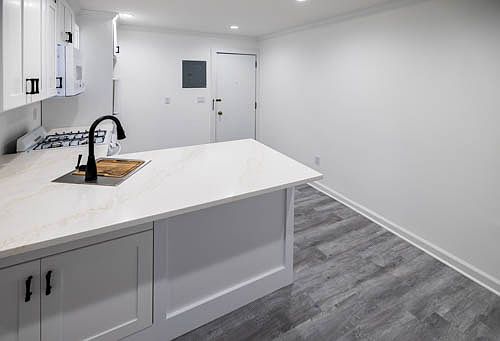 Front door and kitchen area
