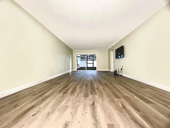 From dining area looking out to living room, lanai and porch