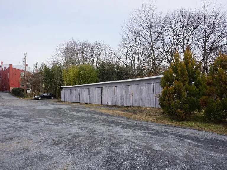 Photo taken from rear of property. Parking area on right.