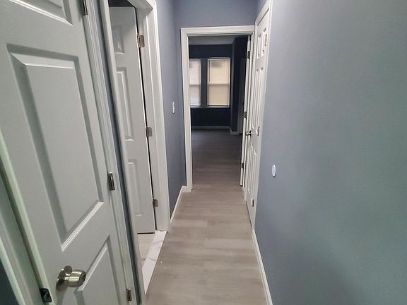hallway with large amount of storage space leading toward the bathroom and master bed room
