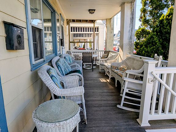 Table for wonderful outdoor dining at end of porch.