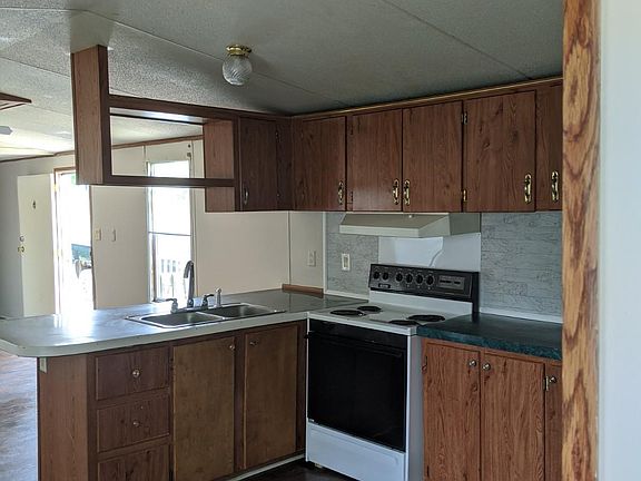 Kitchen with space to seat chairs at bar.