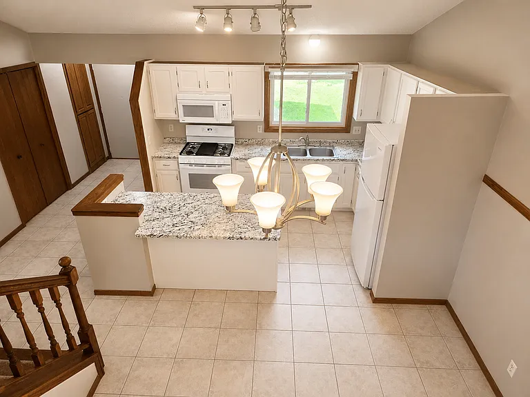 Open concept view from upstairs living down to kitchen and dining area