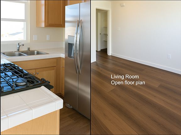 Full size refrigerator and gas stove. View out kitchen window.