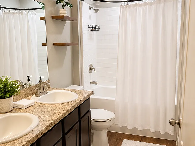 Restroom 1, double sinks, functional cabnietry.