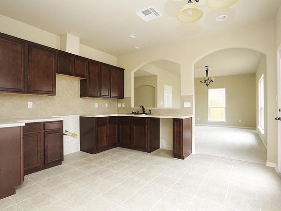 Kitchen has recessed lighting, lots of cabinet space. Oil rubbed bronze fixtures and hardware Tile back splash,